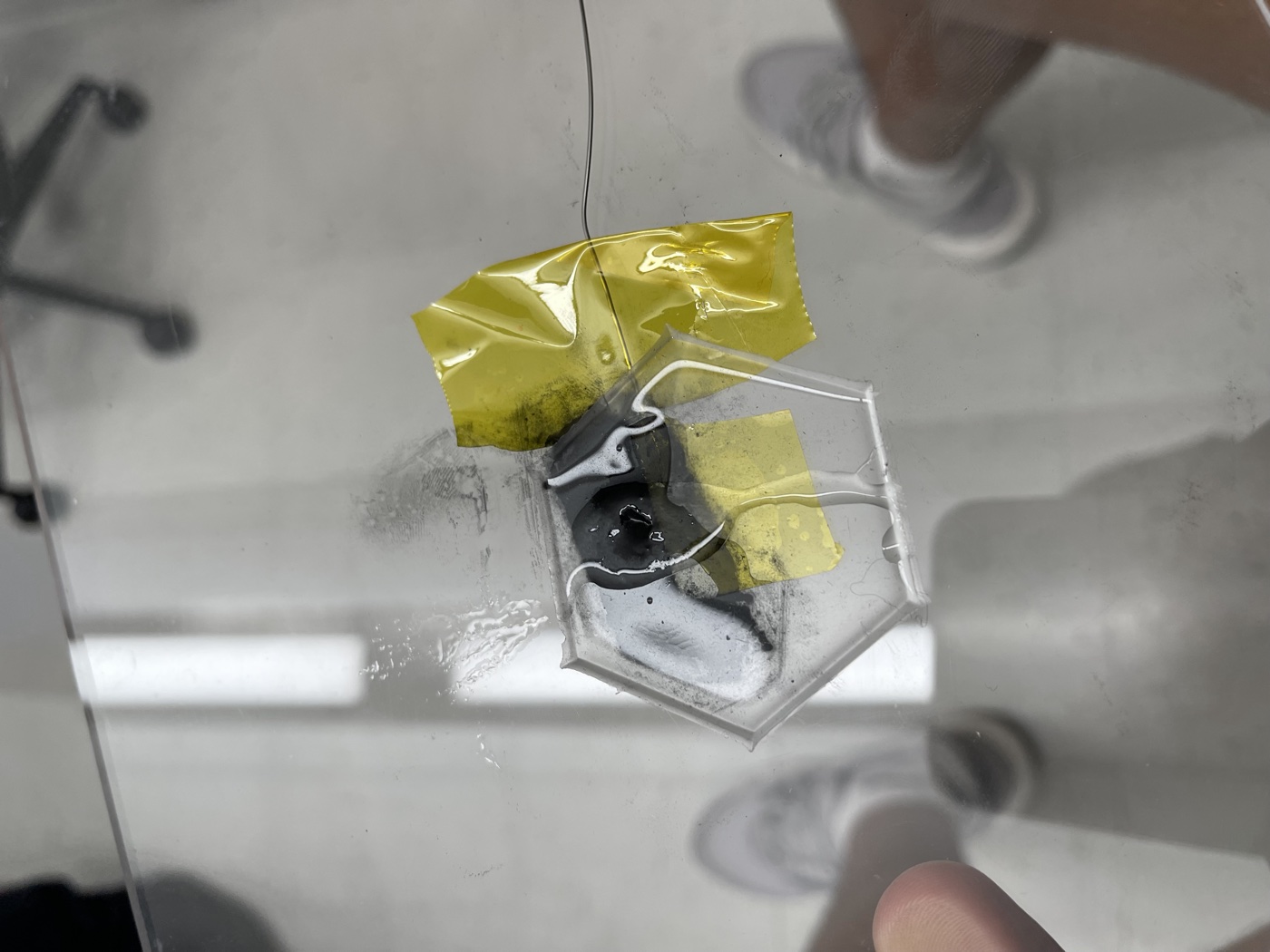 Hexagonal sensor assembly taped to glass for testing